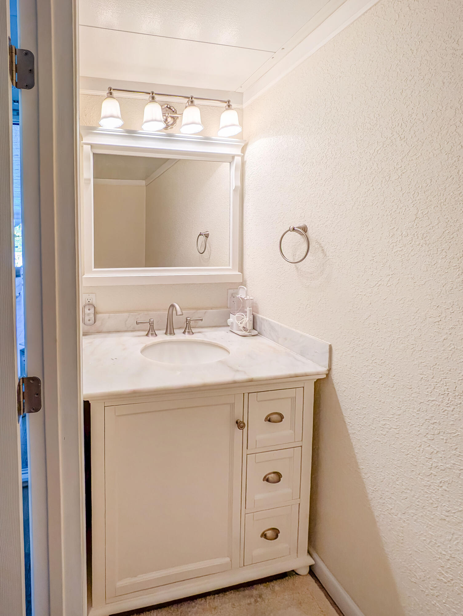 70200 Dillon Road, Unit 493 Desert Hot Springs, CA 92241 - Photo 34 of 35 a bathroom with a granite countertop sink and a mirror