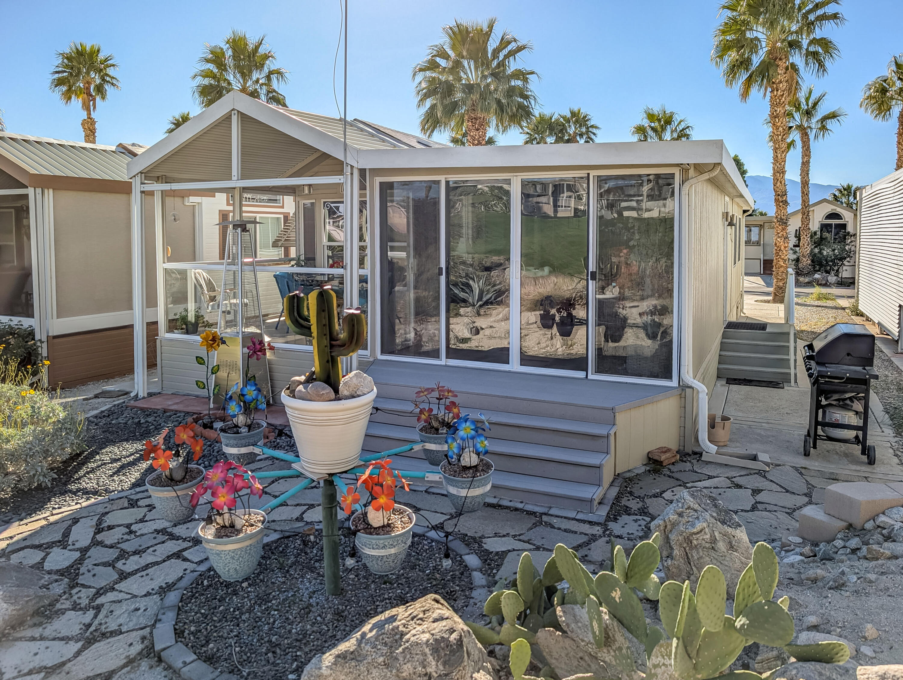 70200 Dillon Road, Unit 493 Desert Hot Springs, CA 92241 - Photo 7 of 35 a view of a chairs and table in the patio