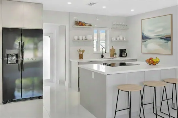 a kitchen with stainless steel appliances a refrigerator and a sink