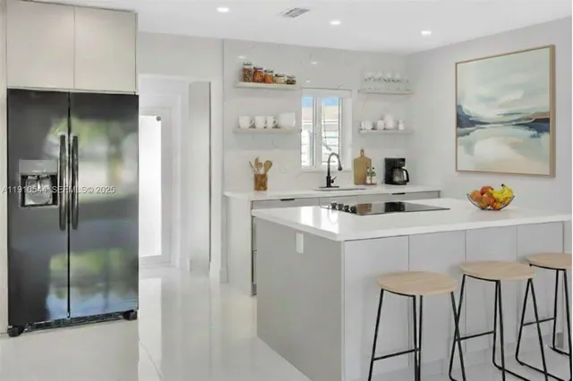 a kitchen with stainless steel appliances granite countertop a stove and a sink