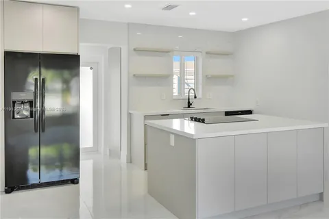 a kitchen with stainless steel appliances granite countertop a stove and a sink