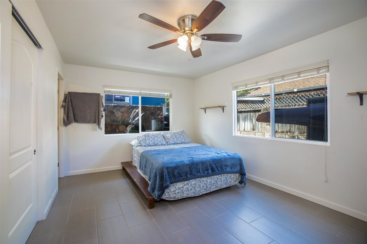 98 East Welakahao Road Kihei, HI 96753 - Photo 14 of 26 a spacious bedroom with a large bed and a window