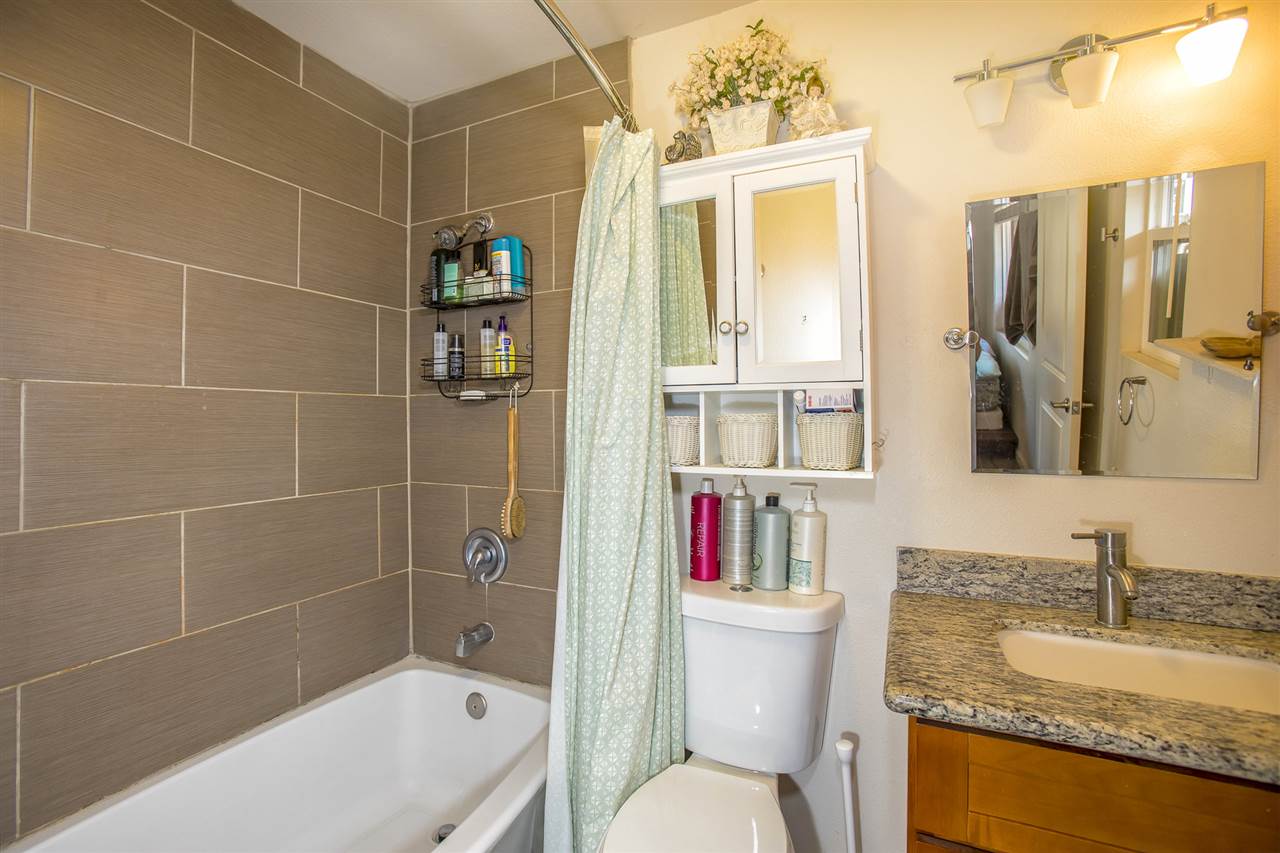 98 East Welakahao Road Kihei, HI 96753 - Photo 16 of 26 a bathroom with a granite countertop sink a toilet and shower
