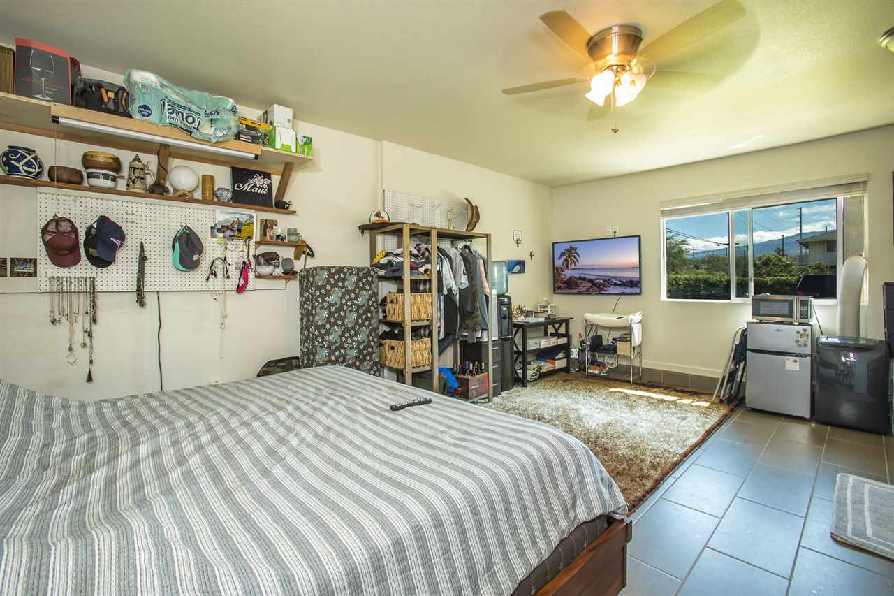 98 East Welakahao Road Kihei, HI 96753 - Photo 19 of 26 a bedroom with bed and glass door