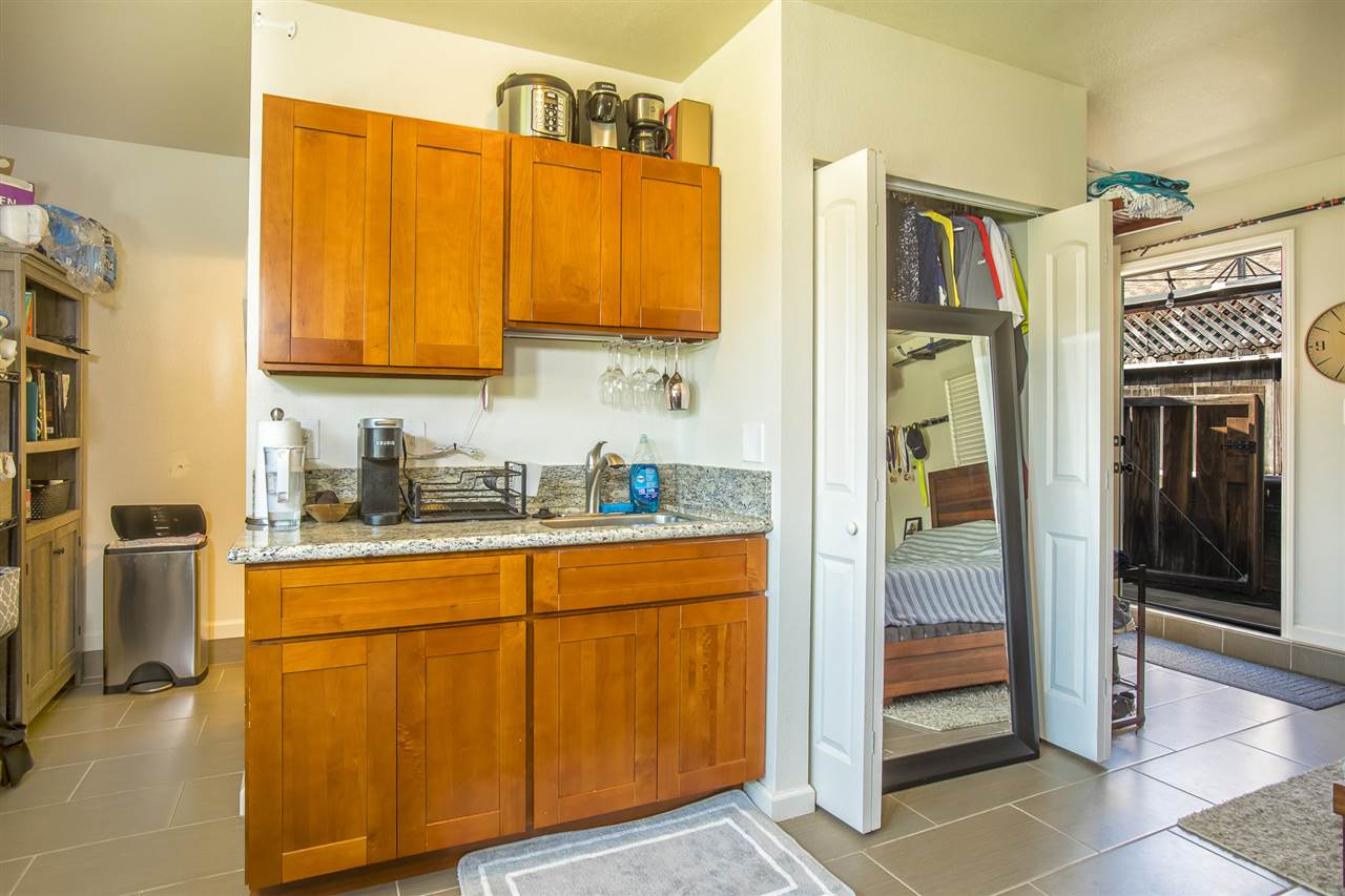 98 East Welakahao Road Kihei, HI 96753 - Photo 21 of 26 a kitchen with stainless steel appliances granite countertop a refrigerator and a sink