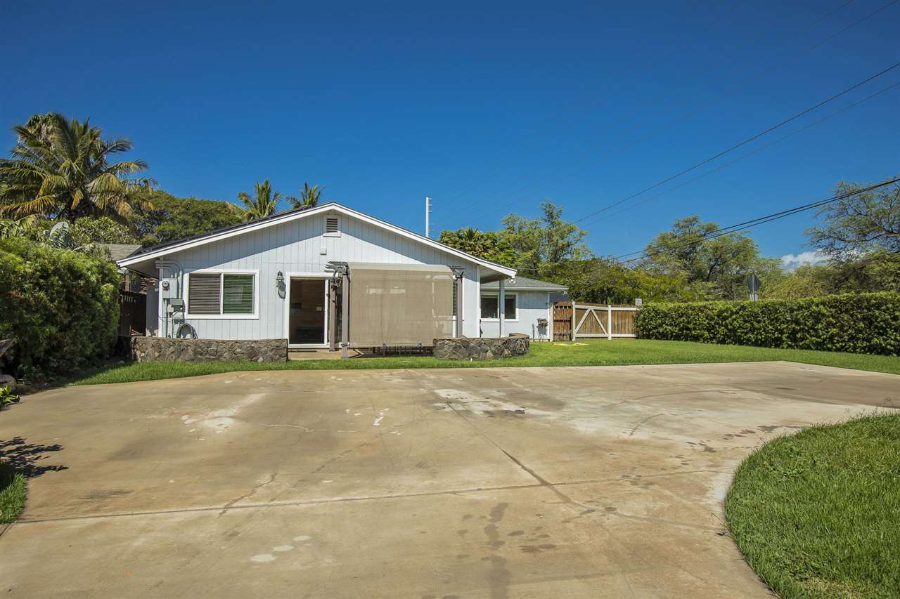98 East Welakahao Road Kihei, HI 96753 - Photo 4 of 26 a front view of a house with a yard and garage