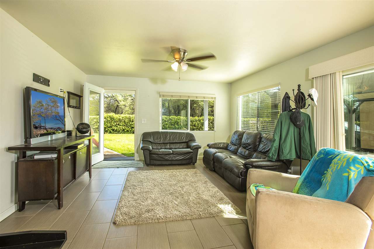 98 East Welakahao Road Kihei, HI 96753 - Photo 6 of 26 a living room with furniture and a flat screen tv