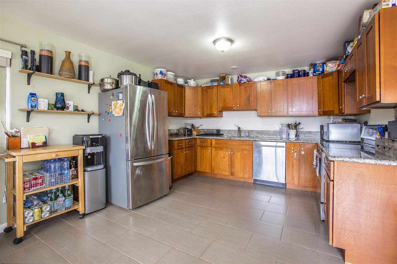 98 East Welakahao Road Kihei, HI 96753 - Photo 8 of 26 a kitchen with stainless steel appliances a stove a sink and a refrigerator