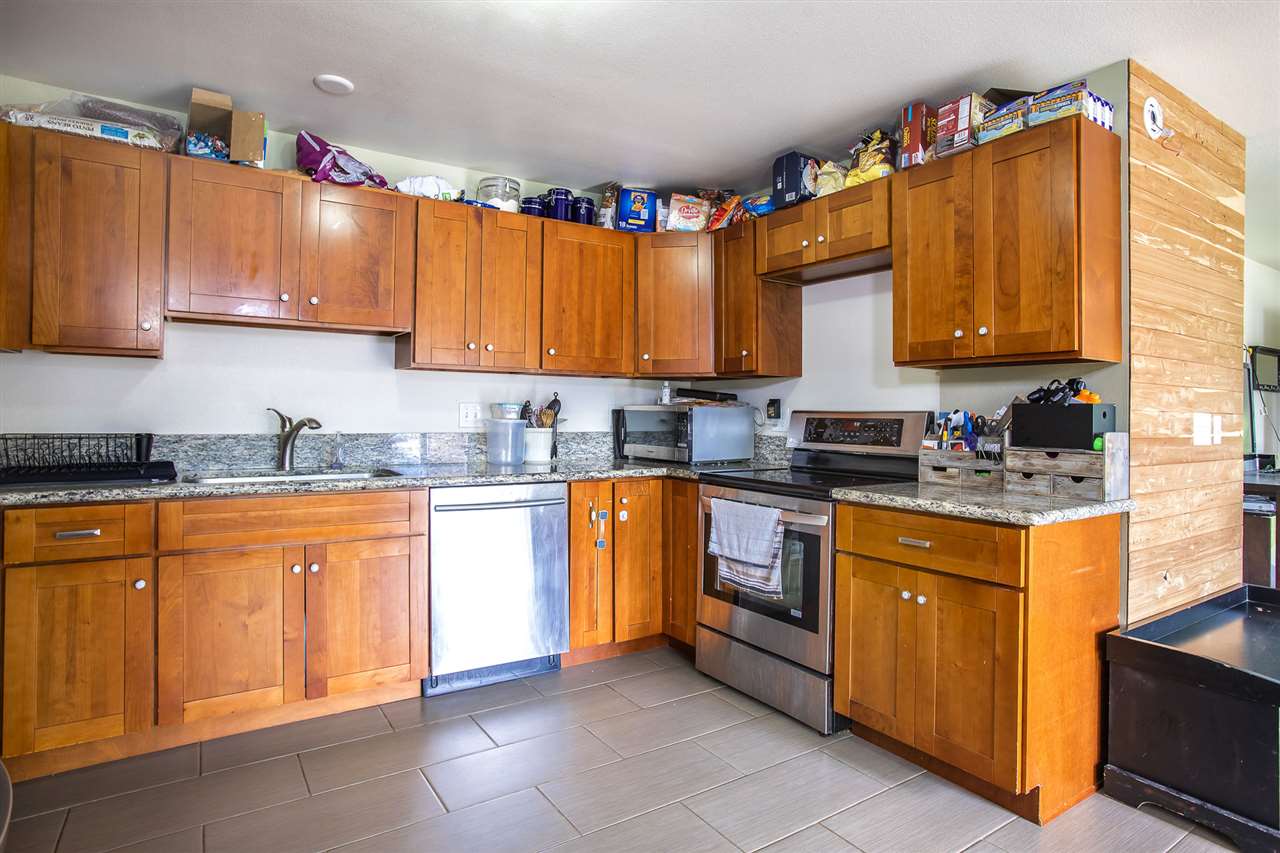 98 East Welakahao Road Kihei, HI 96753 - Photo 9 of 26 a kitchen with stainless steel appliances granite countertop a sink a stove and a refrigerator