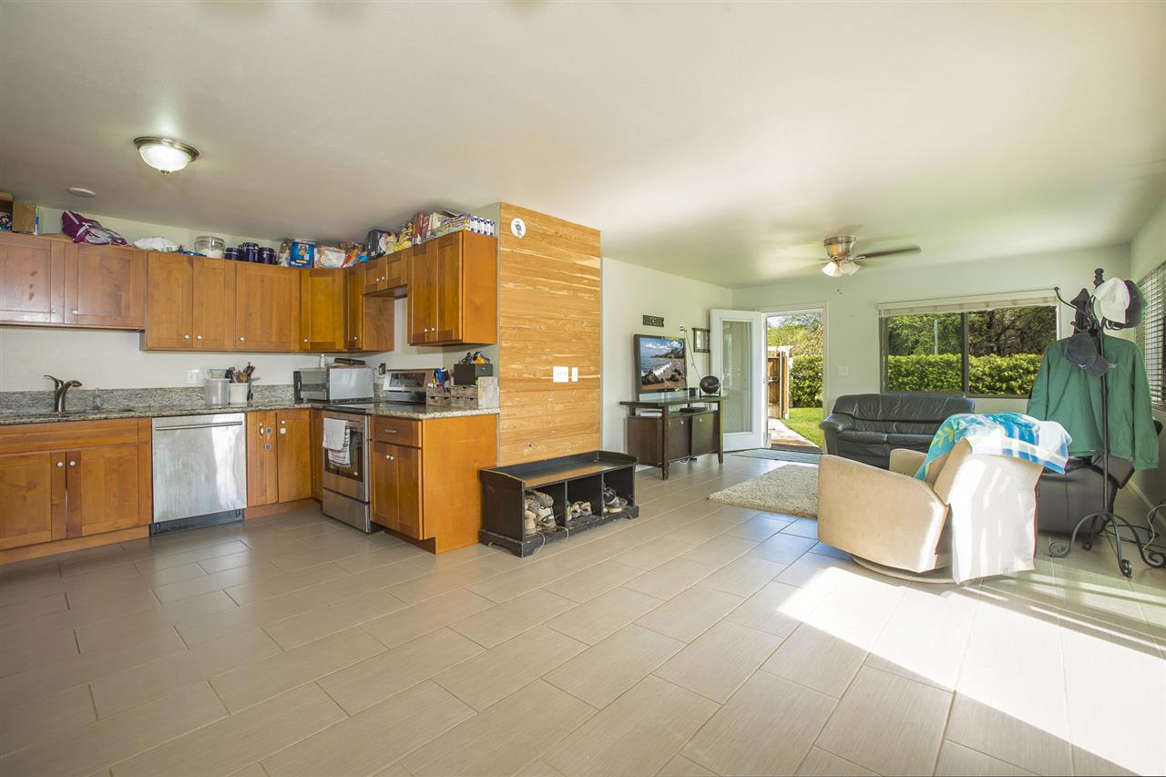 98 East Welakahao Road Kihei, HI 96753 - Photo 10 of 26 a kitchen with stainless steel appliances kitchen island granite countertop a refrigerator and a stove