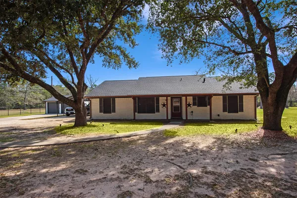 a house that has a big yard with large trees