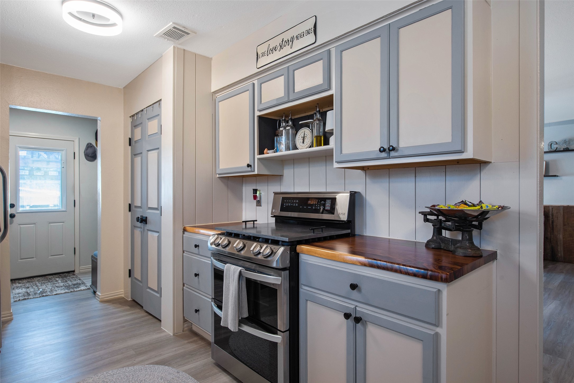 12998 Rocky Road Conroe, TX 77306 - Photo 21 of 50 a kitchen with stainless steel appliances granite countertop a stove and a white cabinets