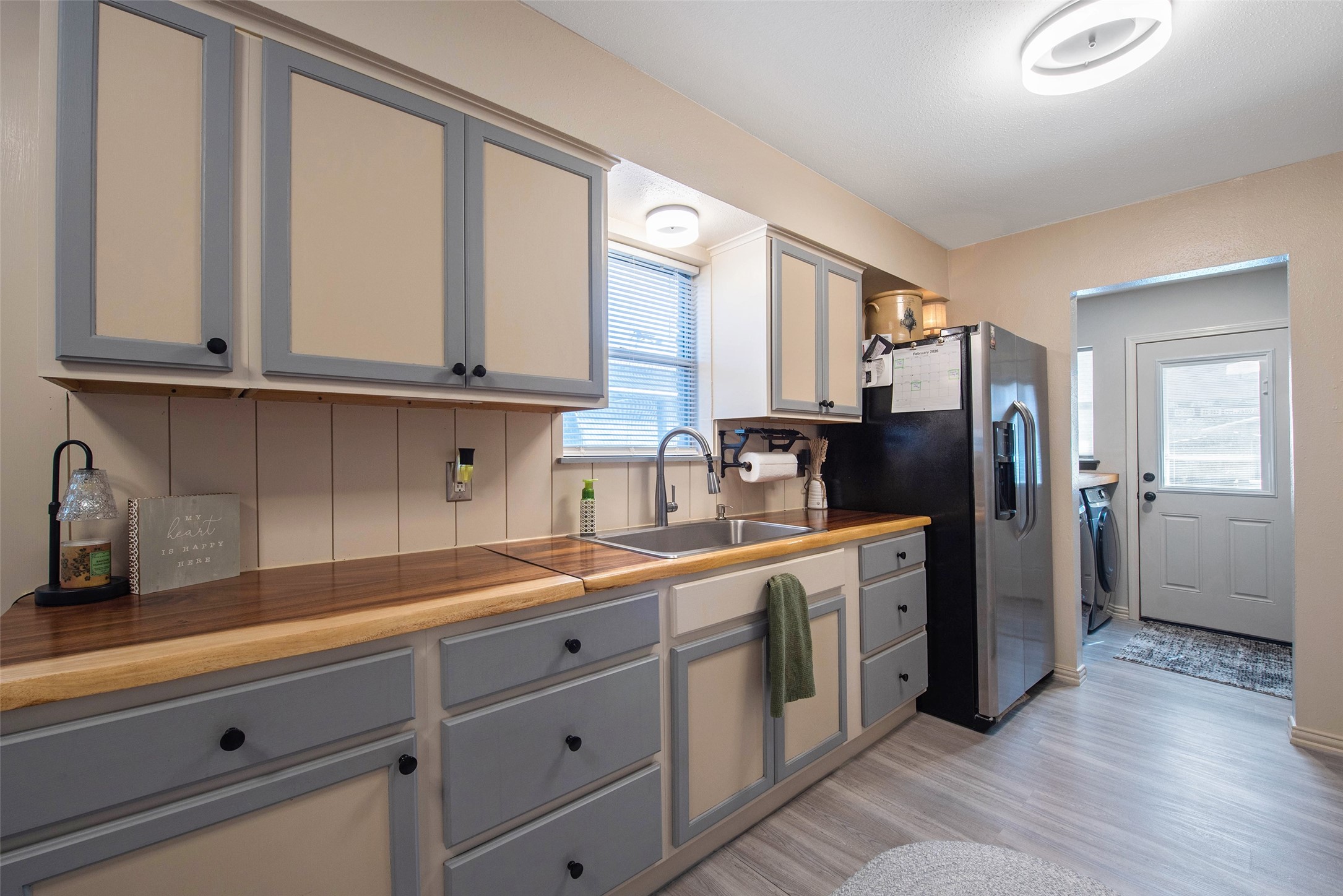 12998 Rocky Road Conroe, TX 77306 - Photo 22 of 50 a kitchen with a sink dishwasher a refrigerator and cabinets