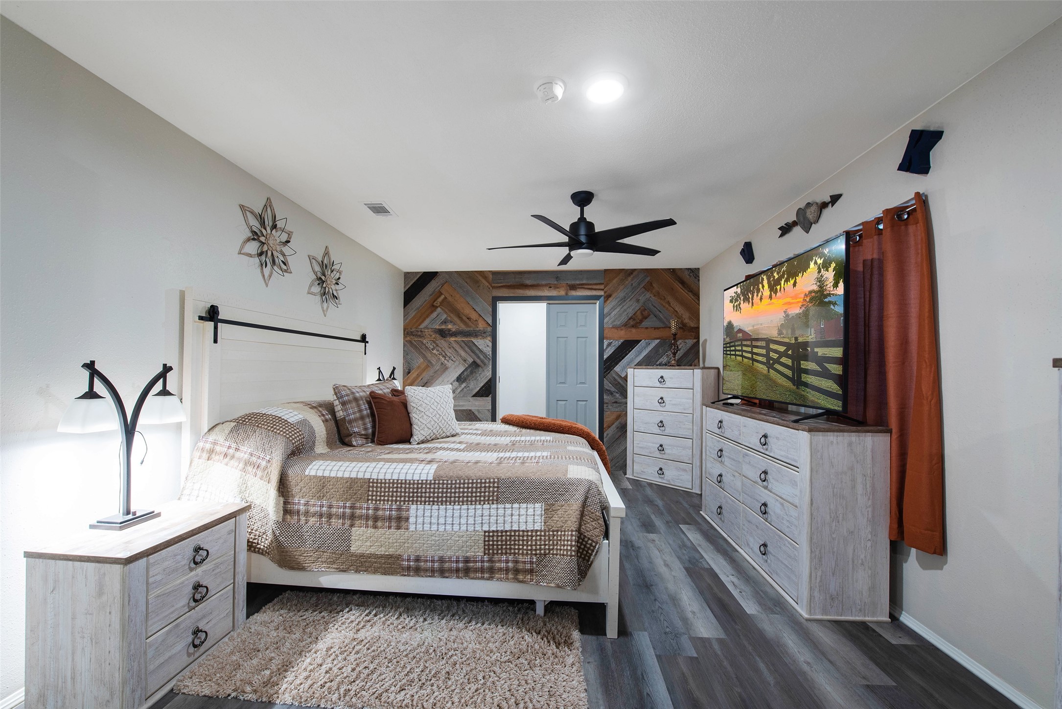 12998 Rocky Road Conroe, TX 77306 - Photo 27 of 50 a bedroom with a bed and a flat screen tv