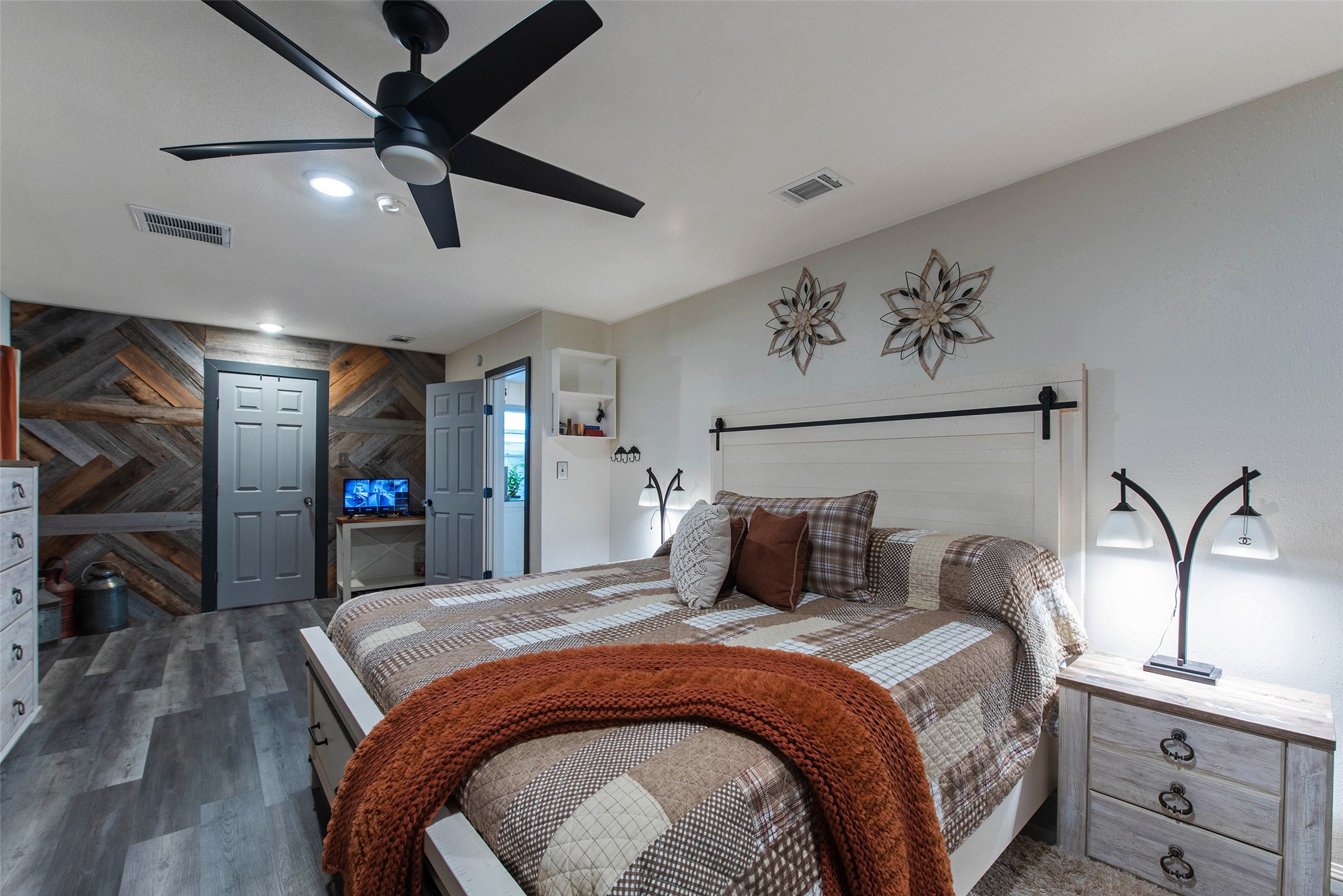 12998 Rocky Road Conroe, TX 77306 - Photo 28 of 50 a bedroom with a large bed and a chandelier