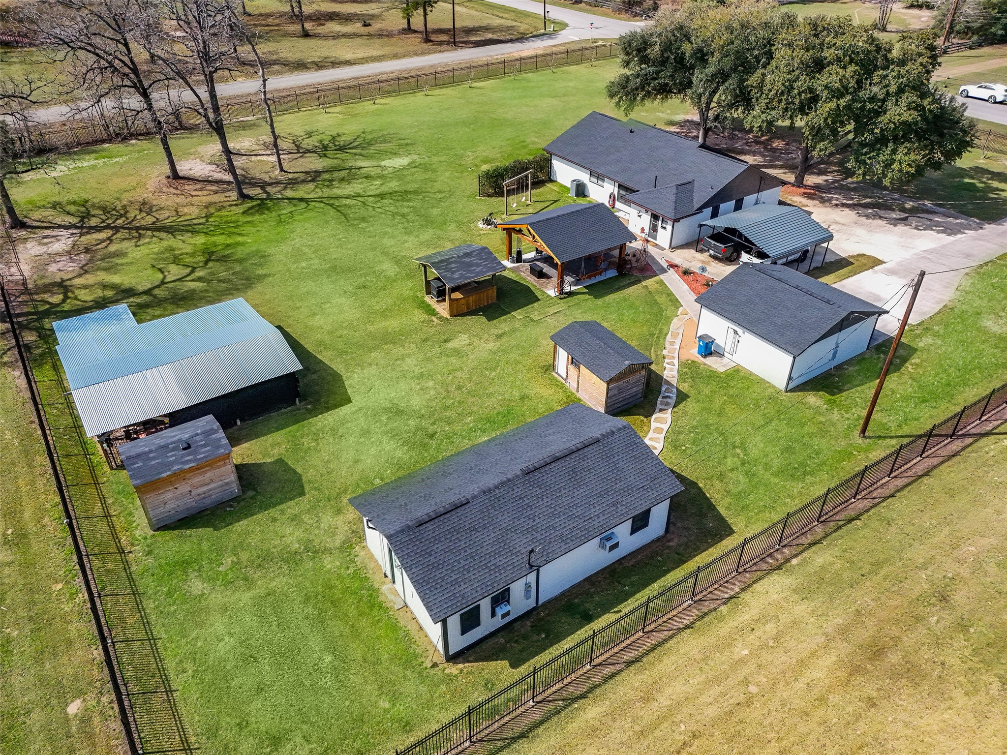 12998 Rocky Road Conroe, TX 77306 - Photo 3 of 50 an aerial view of a house with swimming pool and a yard