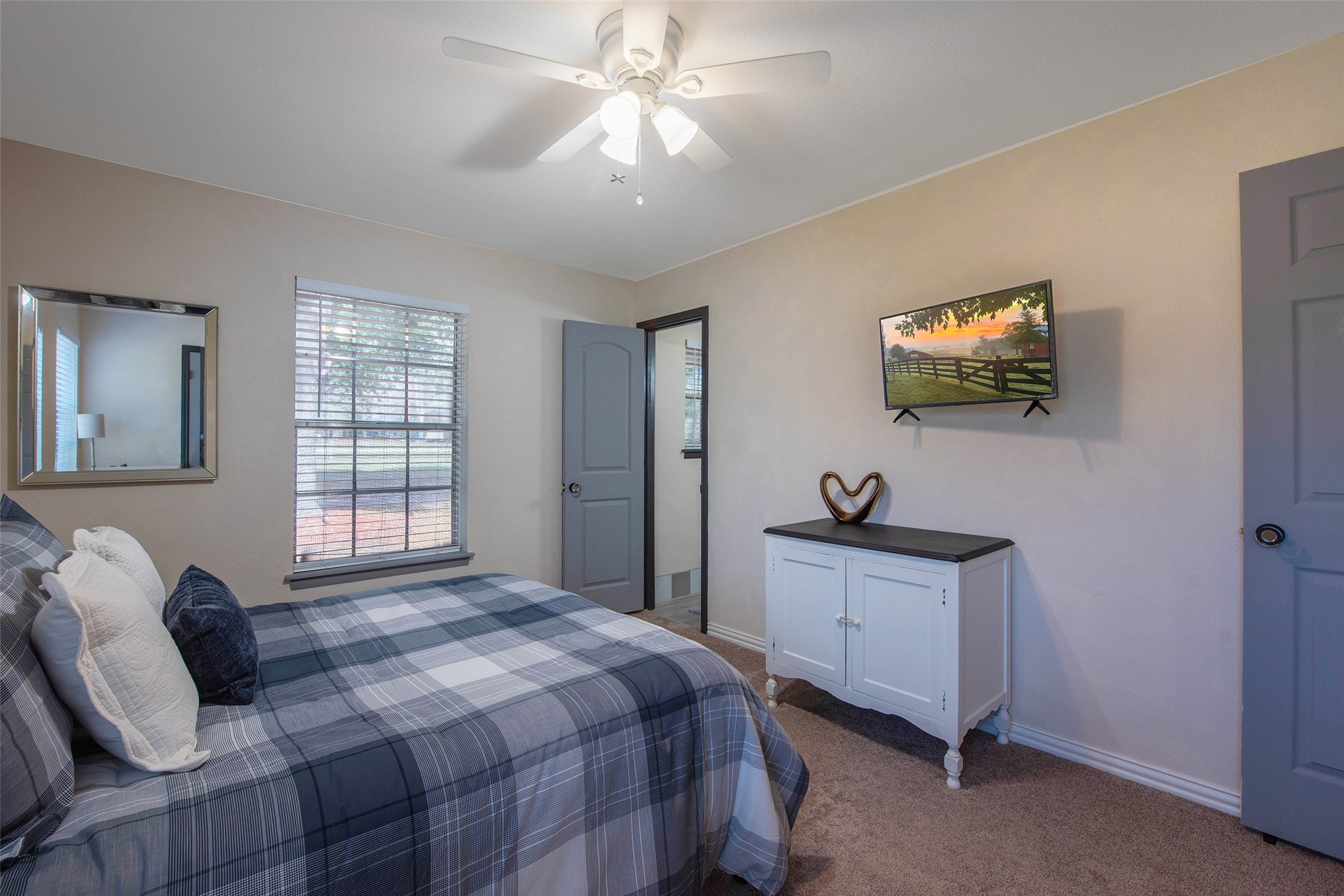 12998 Rocky Road Conroe, TX 77306 - Photo 32 of 50 a bedroom with a bed and a flat screen tv