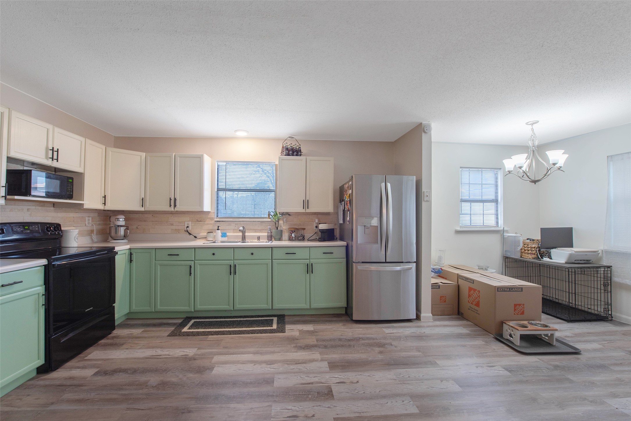 12998 Rocky Road Conroe, TX 77306 - Photo 41 of 50 a kitchen with stainless steel appliances granite countertop a refrigerator sink and microwave