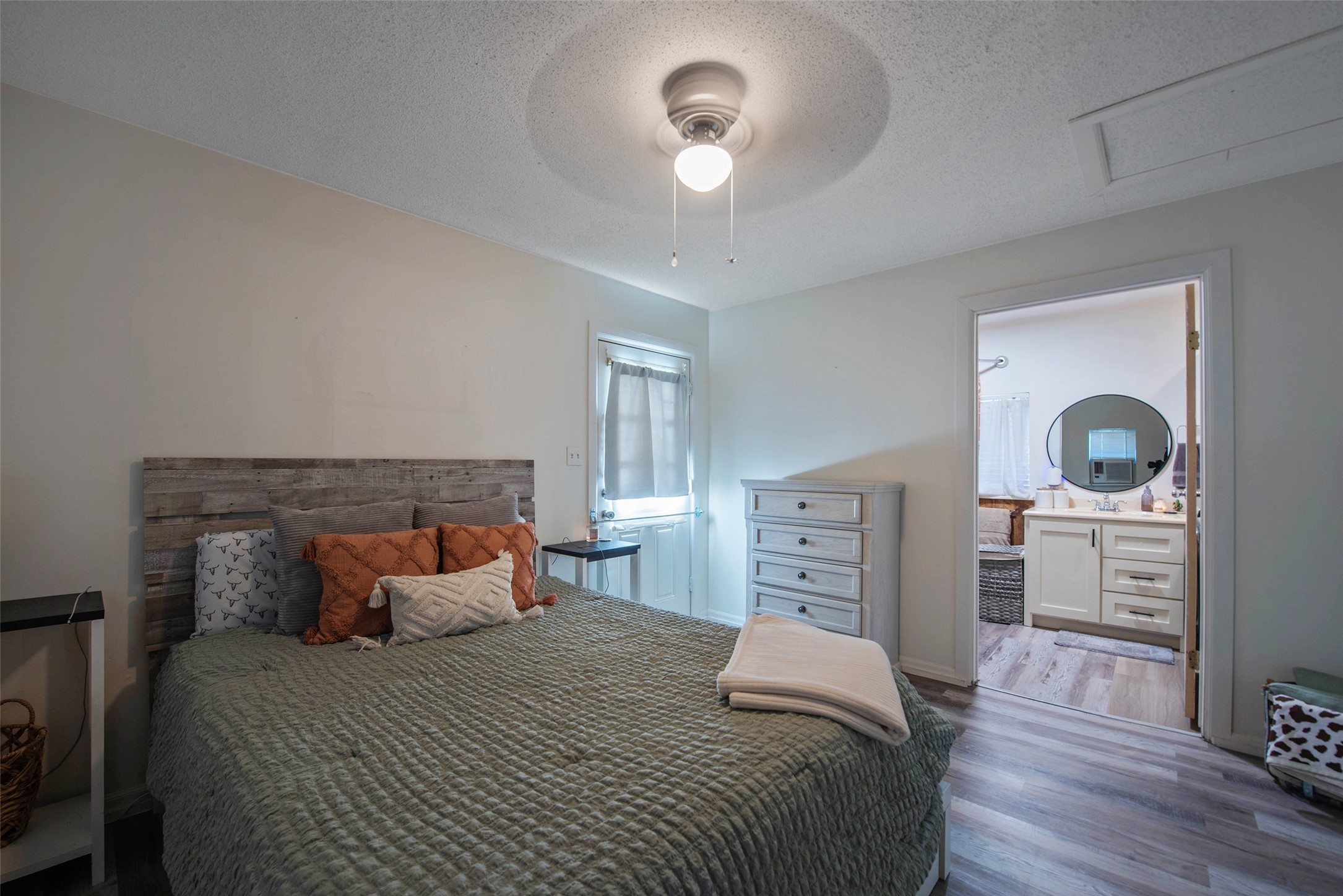 12998 Rocky Road Conroe, TX 77306 - Photo 42 of 50 a bedroom with a bed and wooden floor
