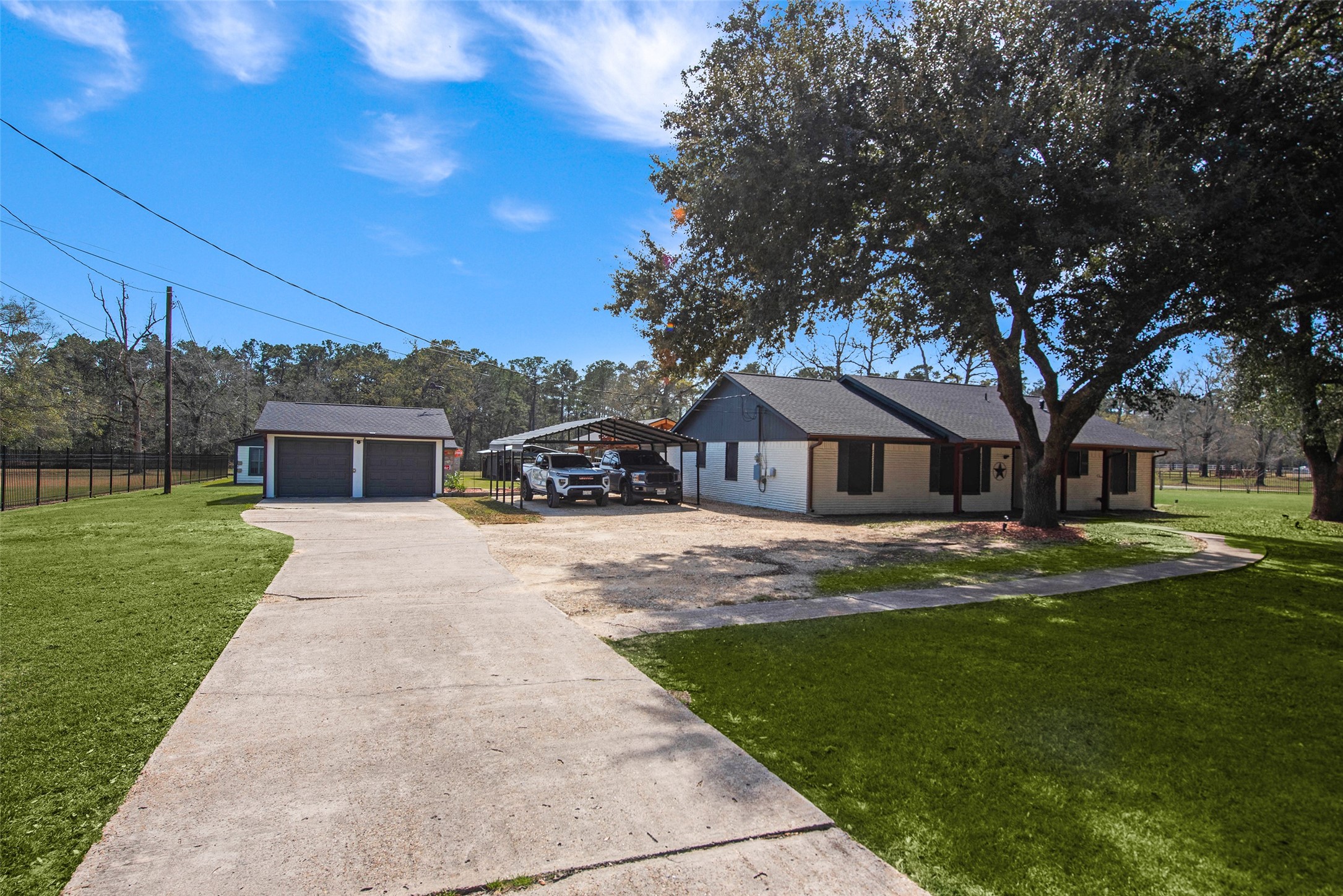 12998 Rocky Road Conroe, TX 77306 - Photo 46 of 50 a front view of a house with a garden and trees