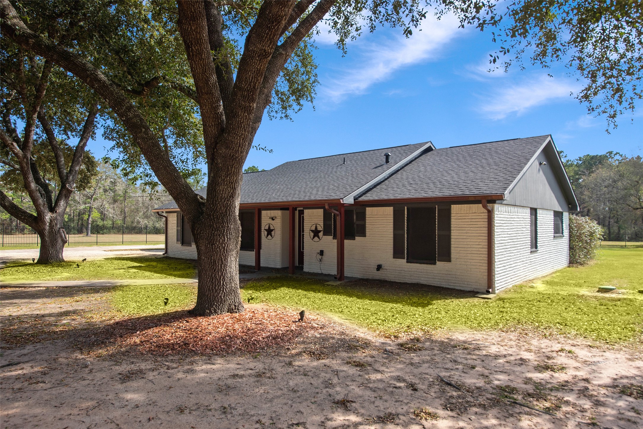 12998 Rocky Road Conroe, TX 77306 - Photo 47 of 50 a house that has a tree in front of it