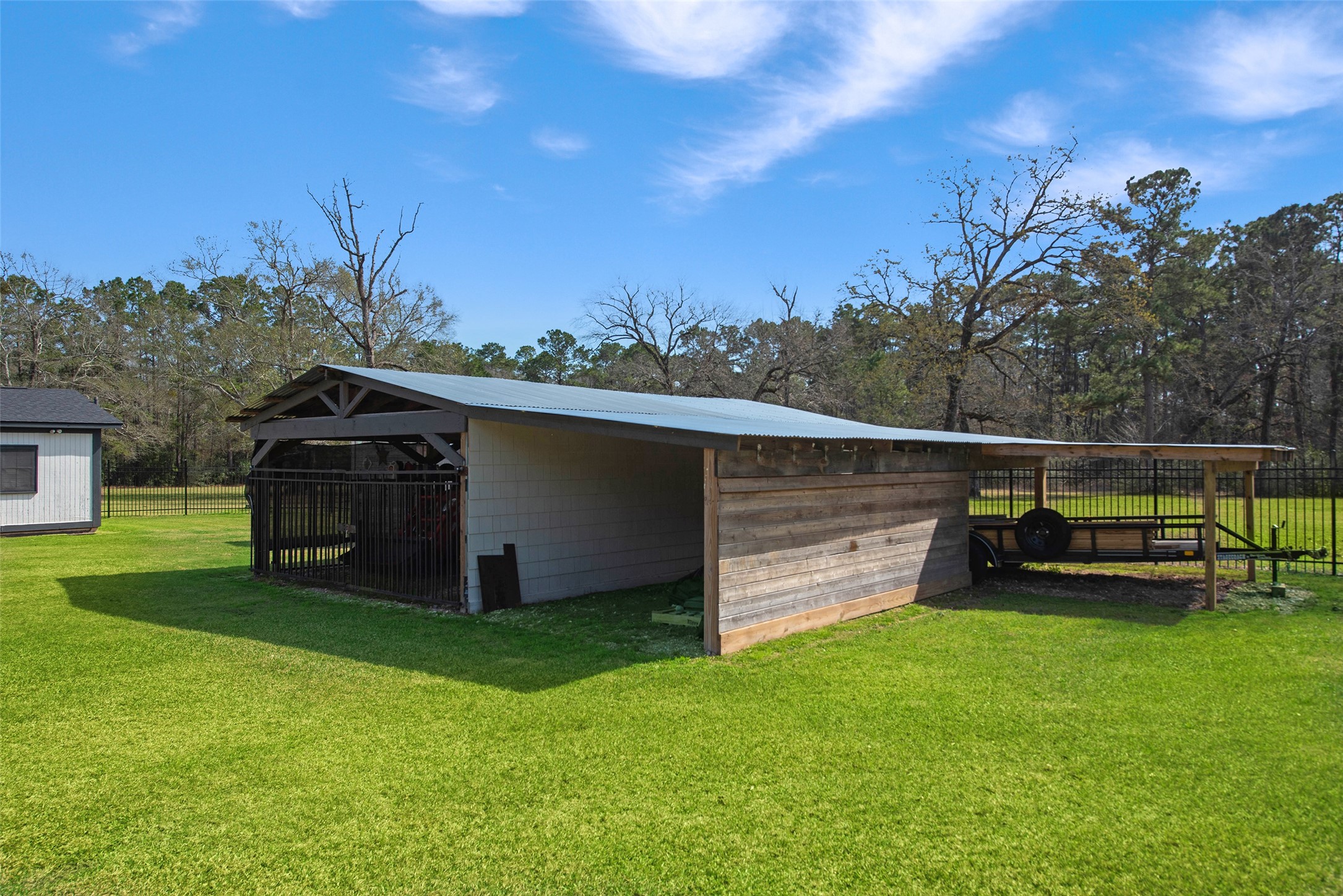 12998 Rocky Road Conroe, TX 77306 - Photo 48 of 50 a view of a backyard with wooden fence and large trees