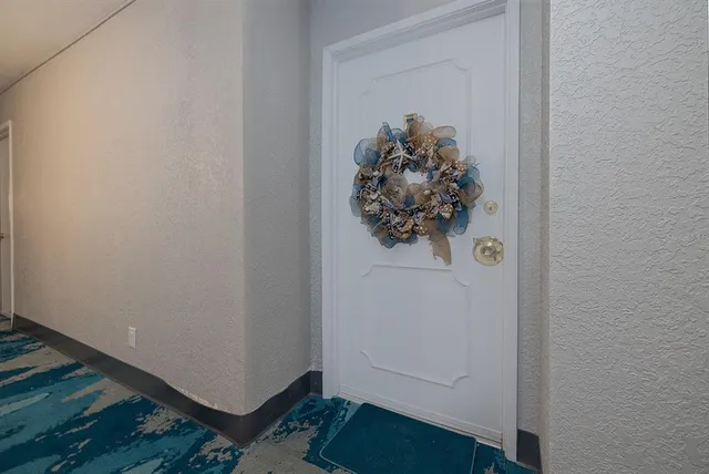a kitchen with a refrigerator and a stove top oven