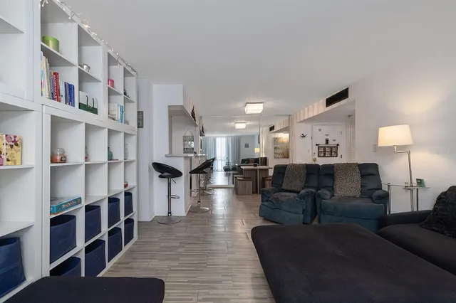 a living room with furniture and a book shelf