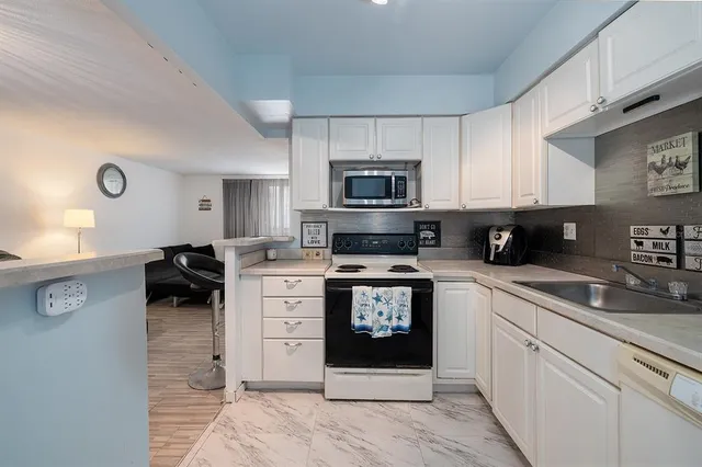 a kitchen with stainless steel appliances granite countertop a stove and a sink