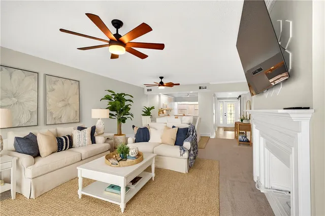 a living room with furniture and a chandelier
