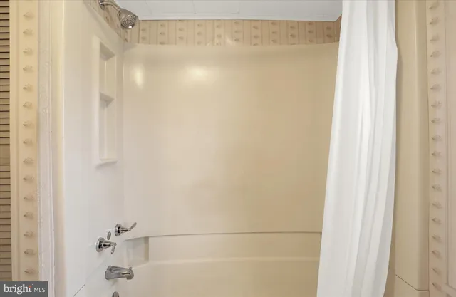 a view of an empty room with closet and window