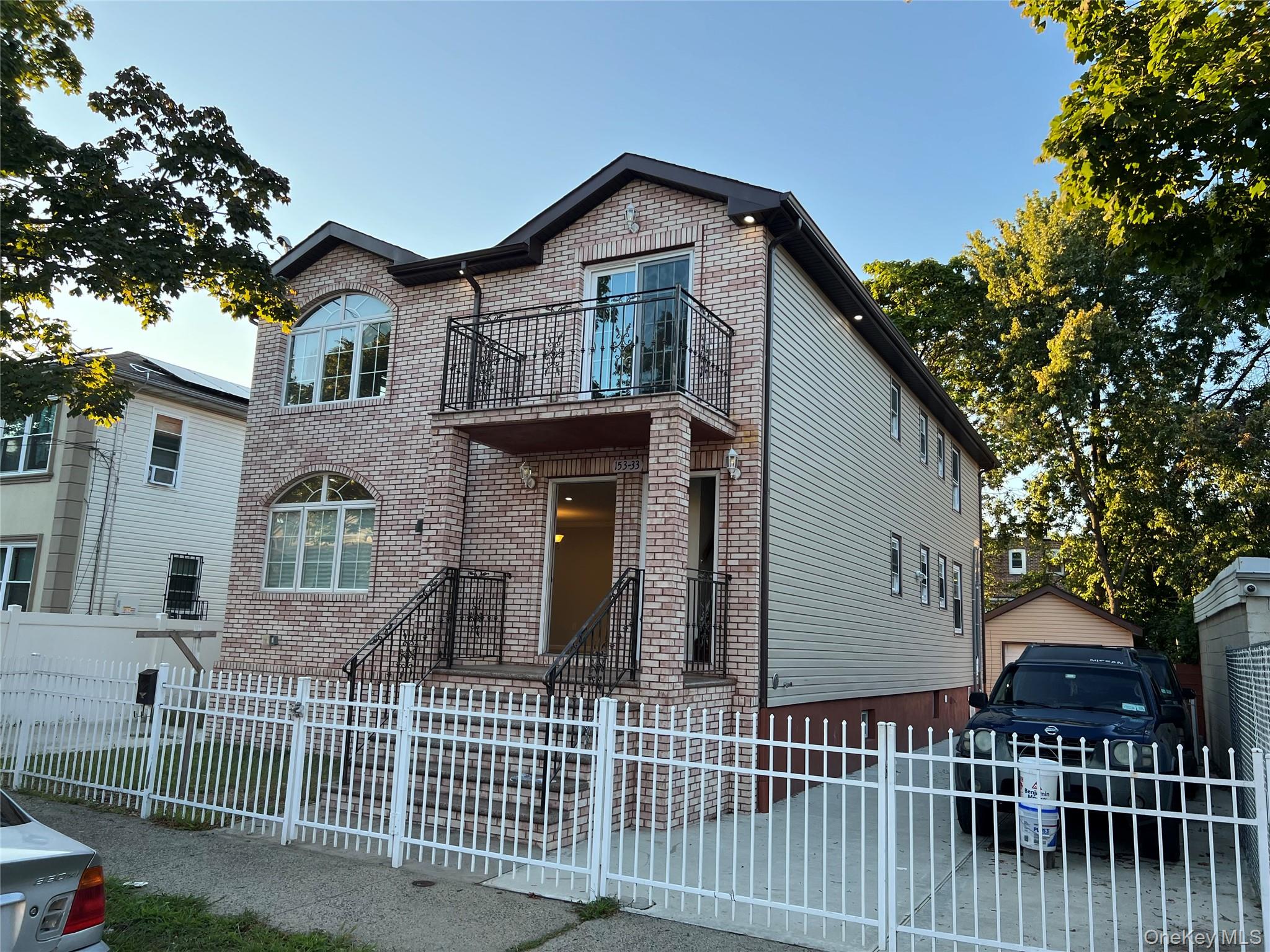 153-33 119th Road Queens, NY 11434 - Photo 2 of 9 a front view of a house with a garden