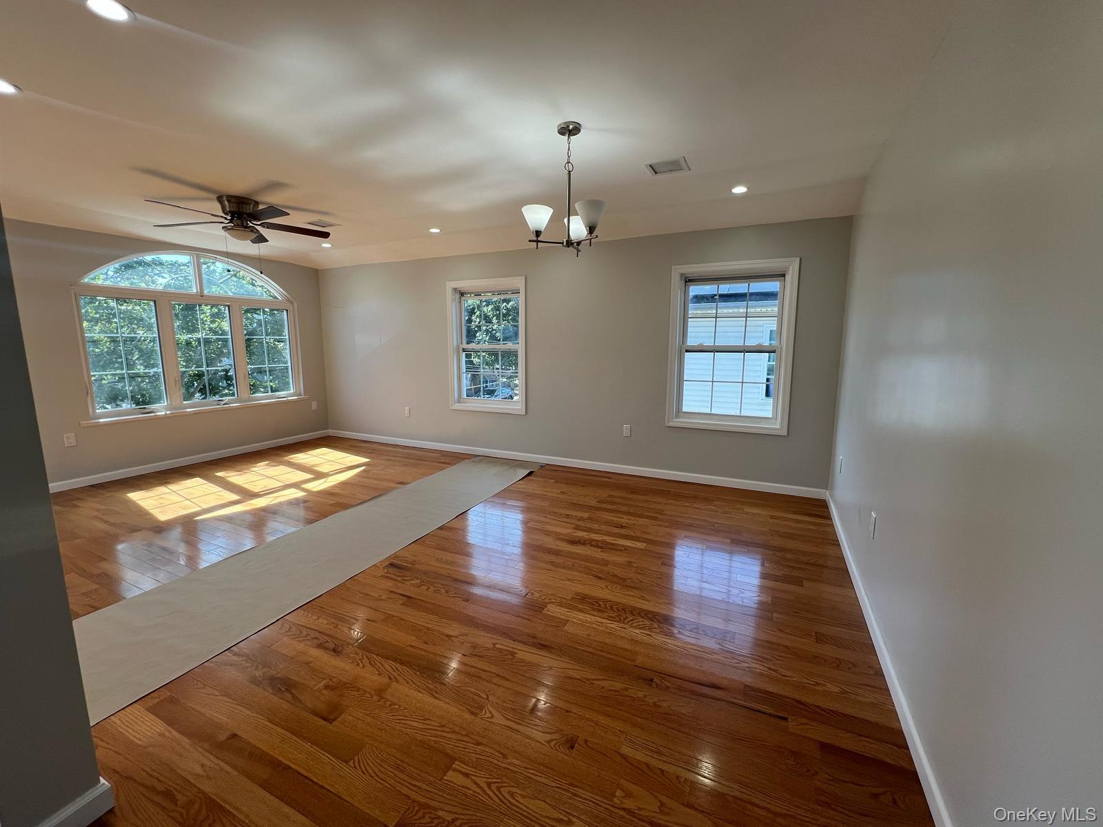 153-33 119th Road Queens, NY 11434 - Photo 8 of 9 wooden floor in an empty room with a window