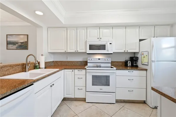 a kitchen with stainless steel appliances granite countertop a sink and a refrigerator