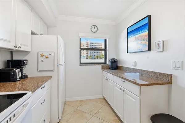 a view with granite countertop a sink a counter space and cabinets in it