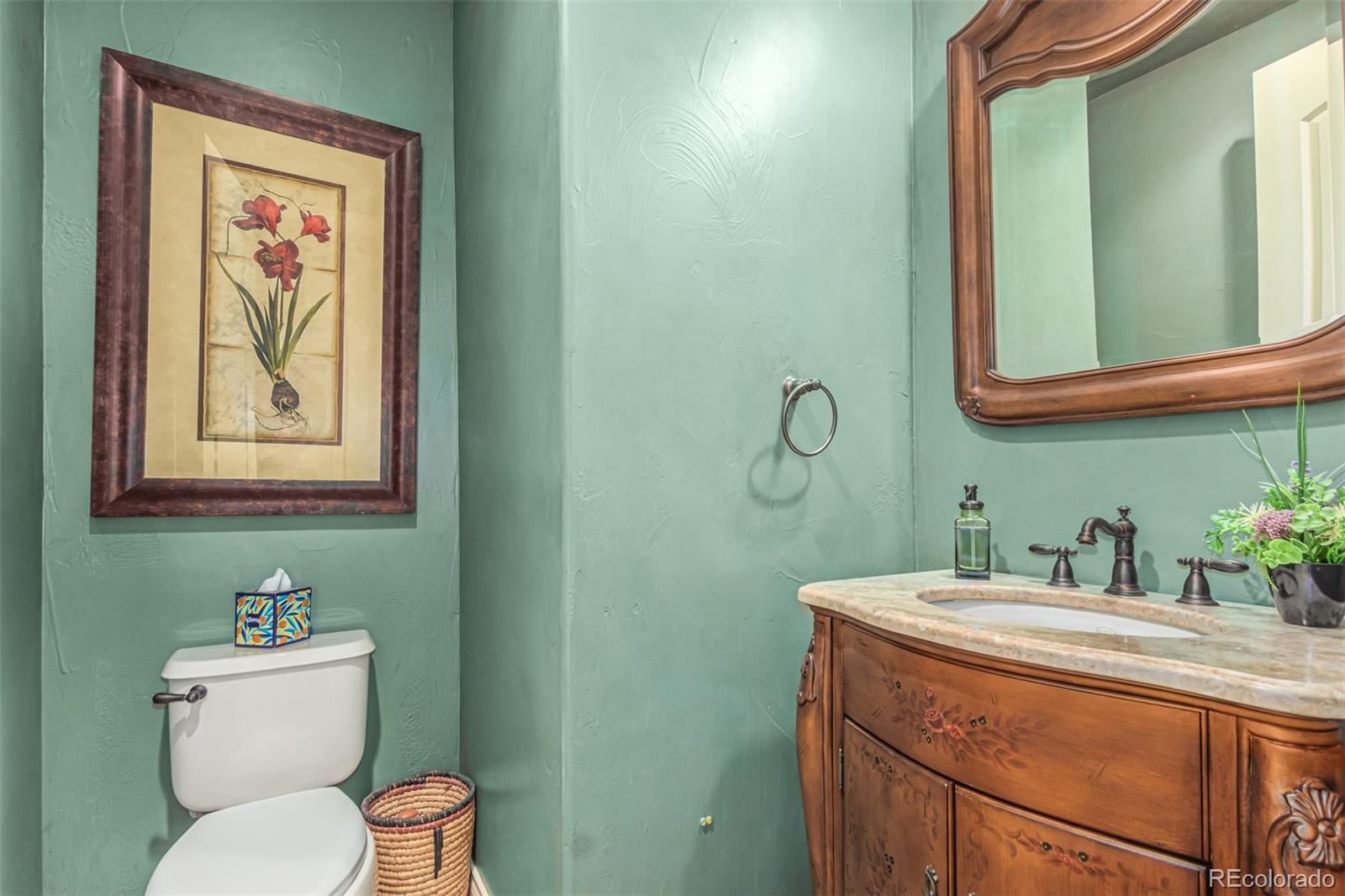 4318 Chateau Ridge Road Castle Rock, CO 80108 - Photo 17 of 50 a bathroom with a toilet sink and mirror