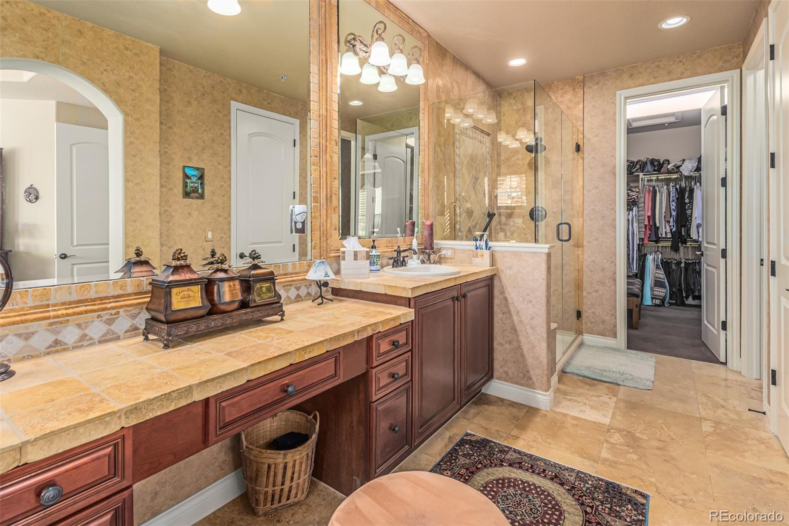 4318 Chateau Ridge Road Castle Rock, CO 80108 - Photo 23 of 50 a spacious bathroom with sinks mirror and a shower