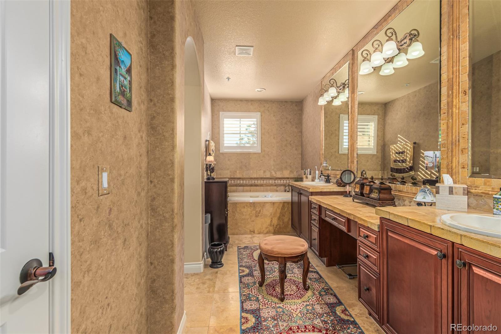 4318 Chateau Ridge Road Castle Rock, CO 80108 - Photo 24 of 50 a large bathroom with a sink a mirror a toilet and a shower