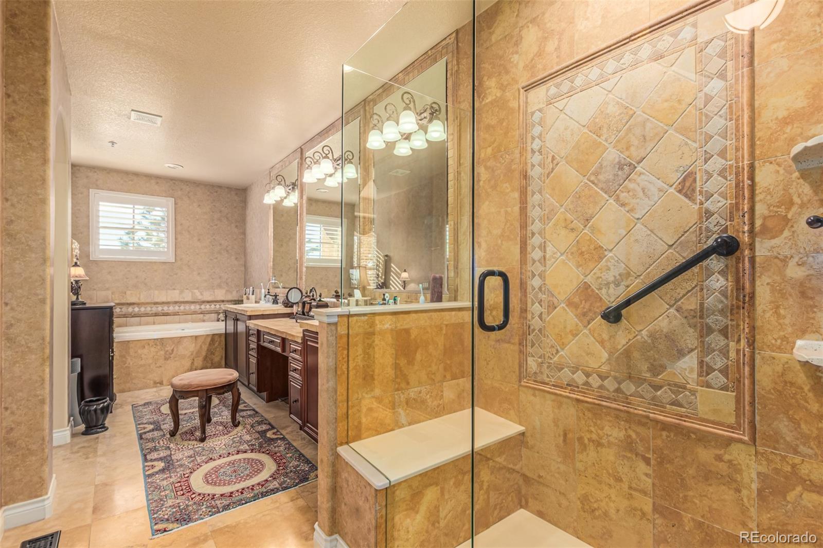 4318 Chateau Ridge Road Castle Rock, CO 80108 - Photo 25 of 50 a bathroom with a double vanity sink a mirror and a shower