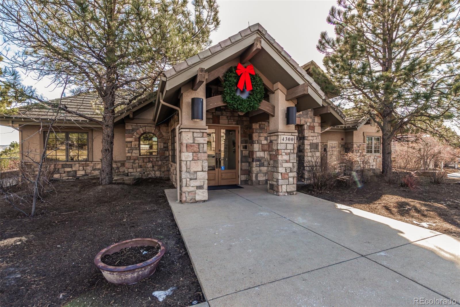 4318 Chateau Ridge Road Castle Rock, CO 80108 - Photo 46 of 50 a view of a house with a yard and garage