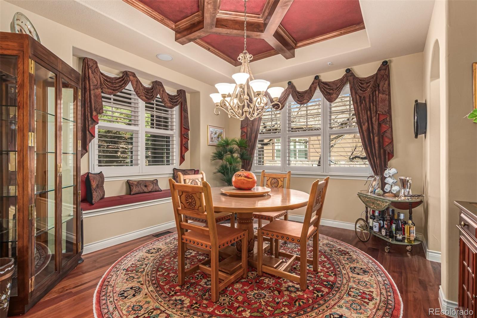 4318 Chateau Ridge Road Castle Rock, CO 80108 - Photo 10 of 50 a dining room with furniture a chandelier and wooden floor