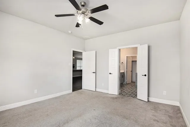 an empty room with closet and windows