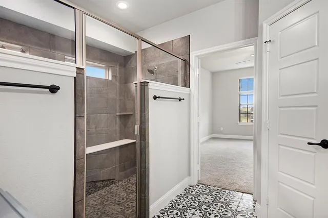 a bathroom with a glass shower door
