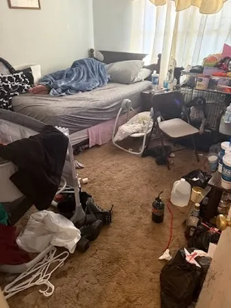 a living room with furniture and a mirror