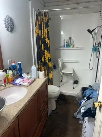a bathroom with a sink mirror vanity and toilet