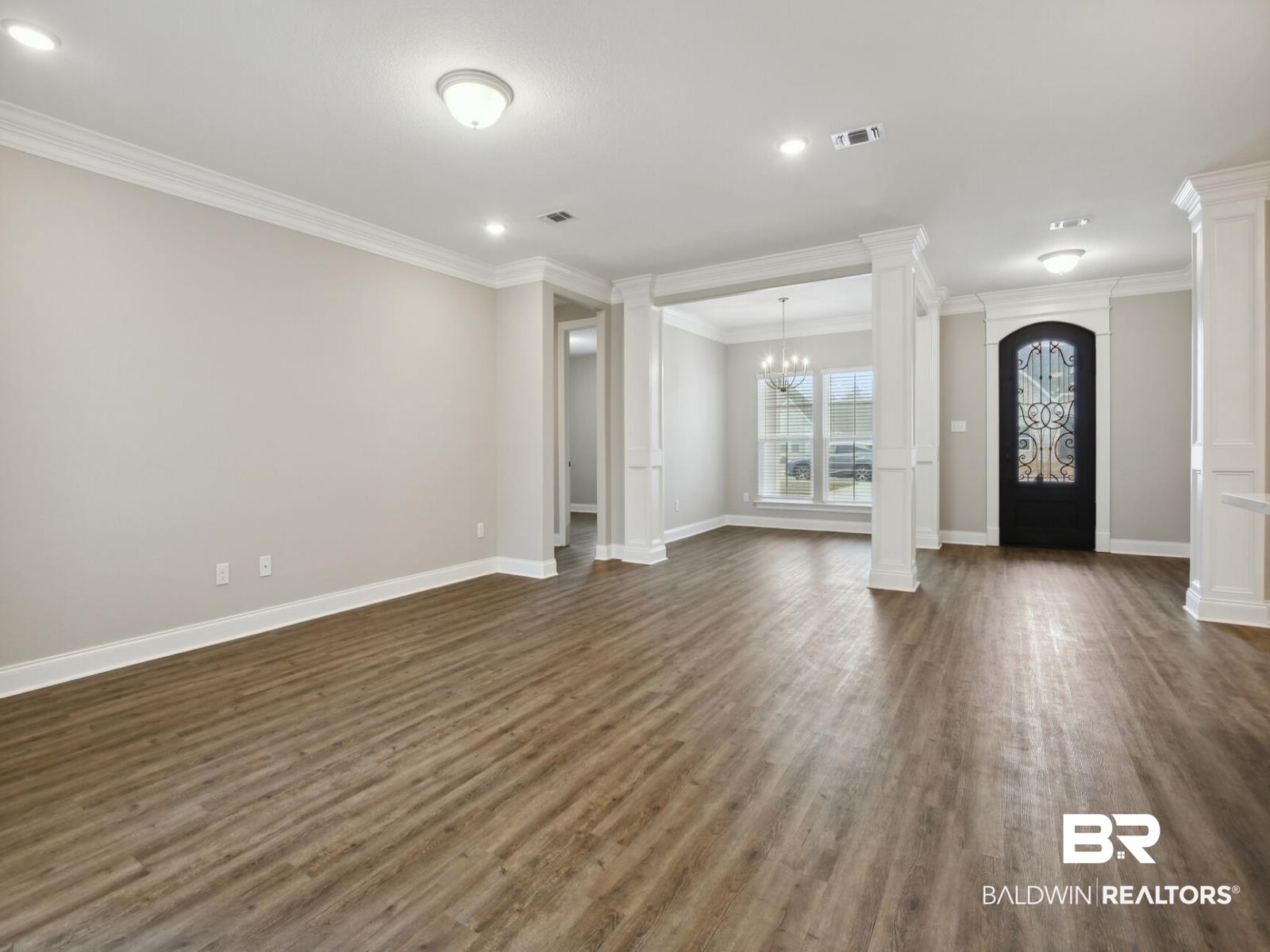 12942 Gondala Street Elberta, AL 36530 - Photo 6 of 18 Entryway with decorative columns, dark wood-type flooring, recessed lighting, a chandelier, and crown molding