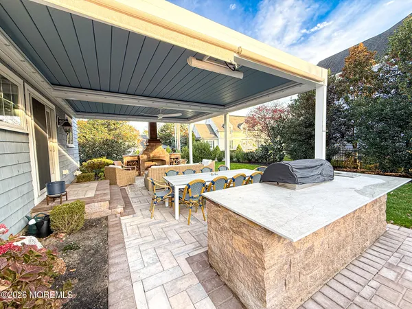 a view of a patio with a dining table and chairs