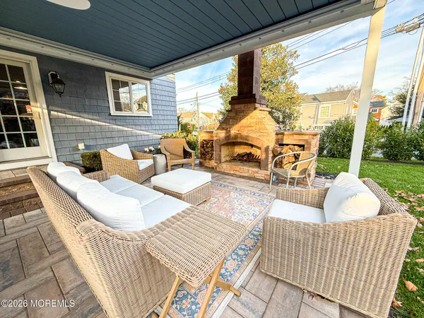 a view of a patio with table and chairs with wooden floor and fence