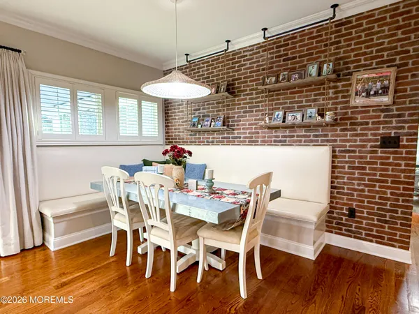 a dining room with furniture and wooden floor
