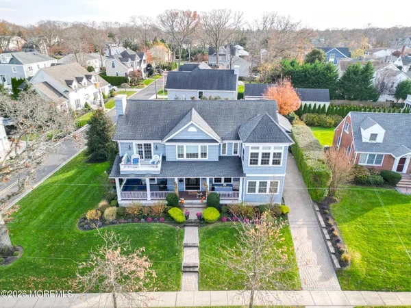 an aerial view of residential houses with outdoor space and street view